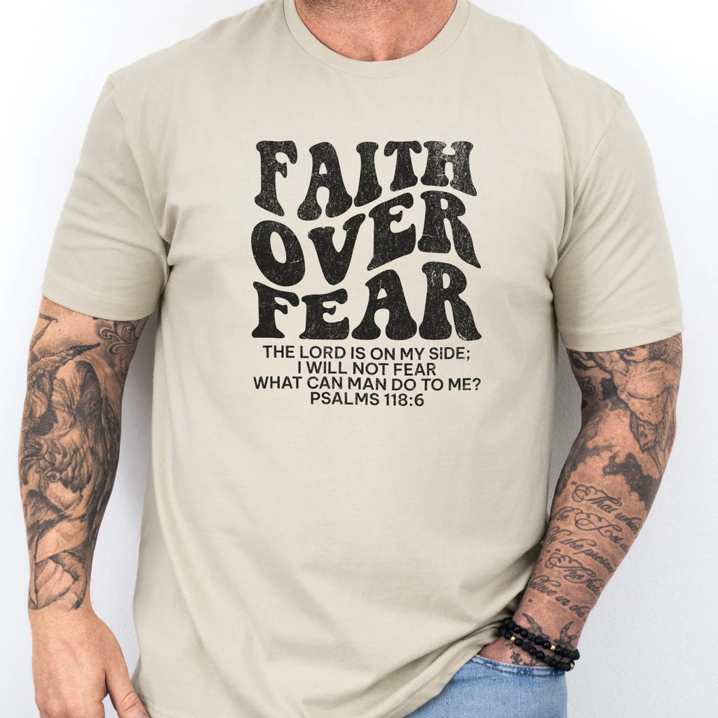 Sand Oakley June t shirt, mens fit, large front lettering reads Faith Over Fear with supporting scripture lines, studio front view