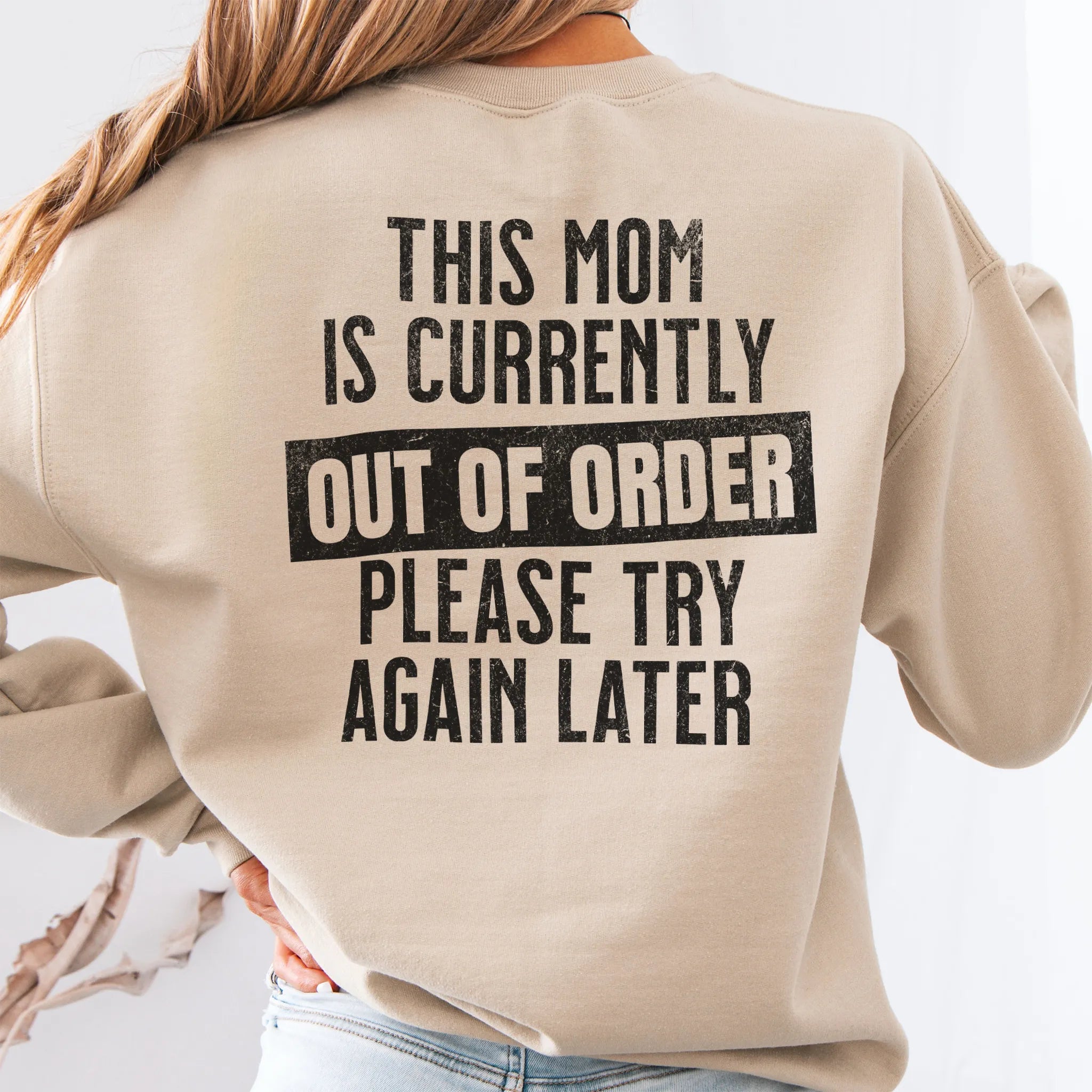 Sand sweatshirt – large back text “This Mom Is Currently Out of Order, Please Try Again Later”, relaxed modern fit, studio back view