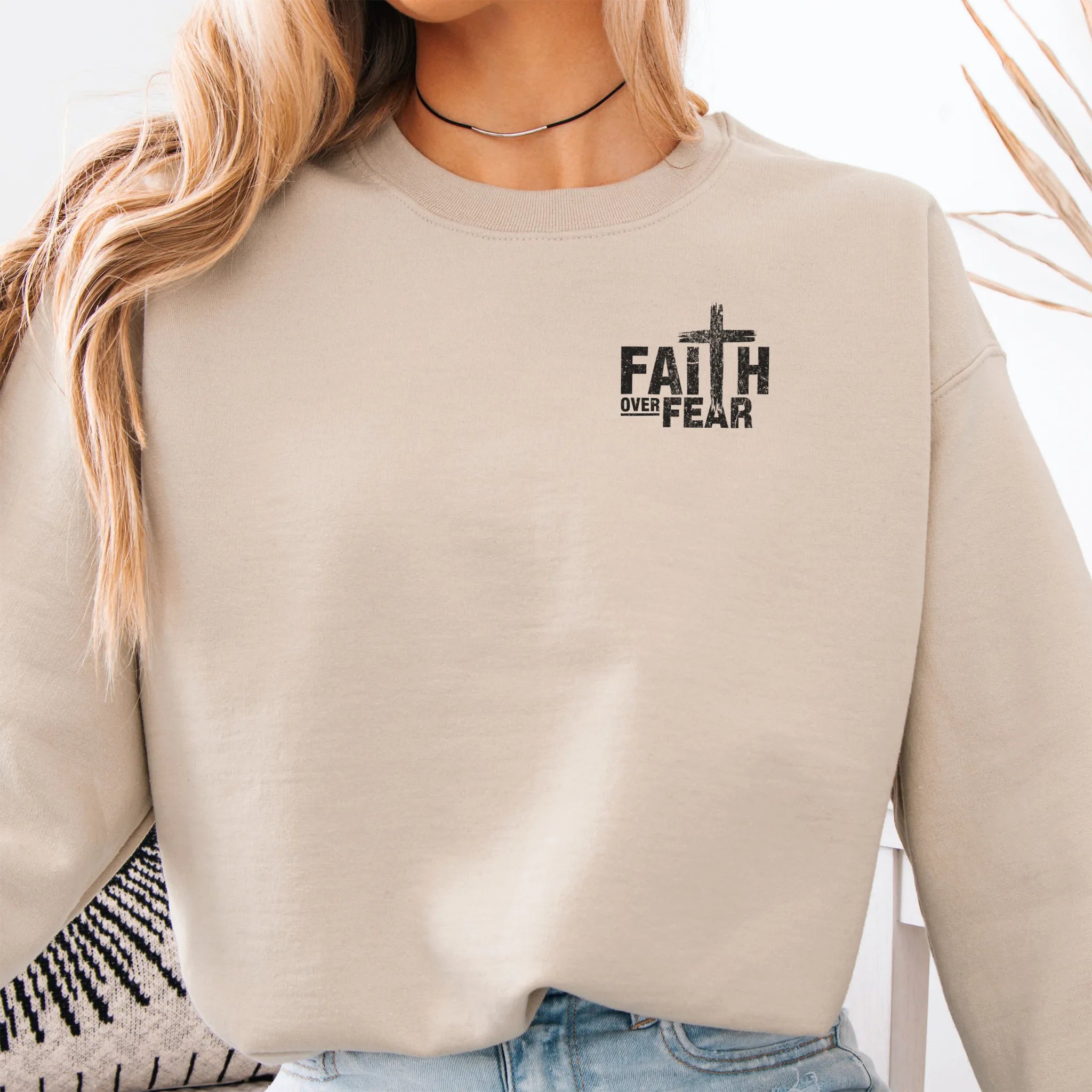 Sand Oakley June sweatshirt, left chest badge reads Faith Over Fear with small cross, relaxed modern fit, studio front view