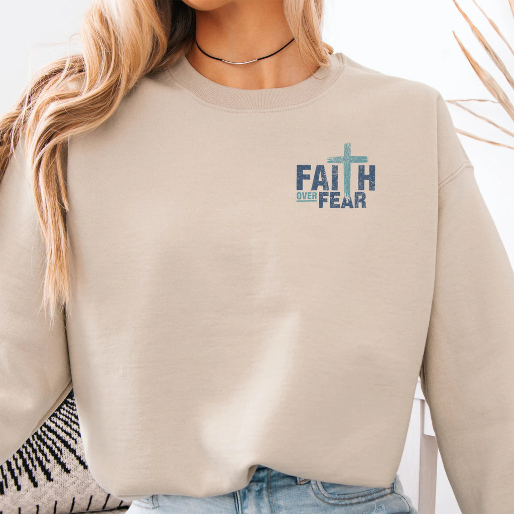 Sand Oakley June sweatshirt, left chest badge reads Faith Over Fear with small cross, relaxed modern fit, studio front view
