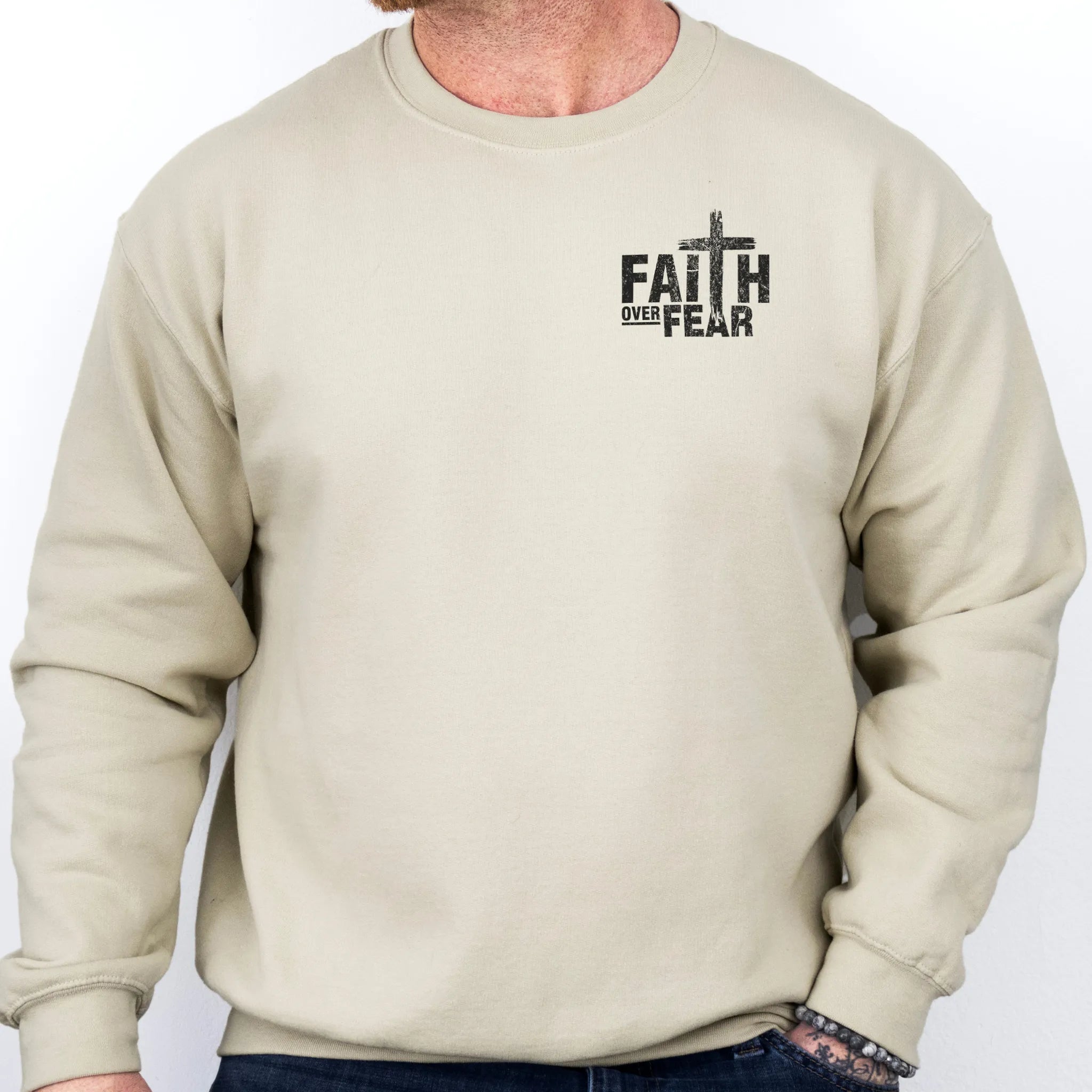 Sand Oakley June sweatshirt, mens fit, left chest badge reads Faith Over Fear with cross, studio front view