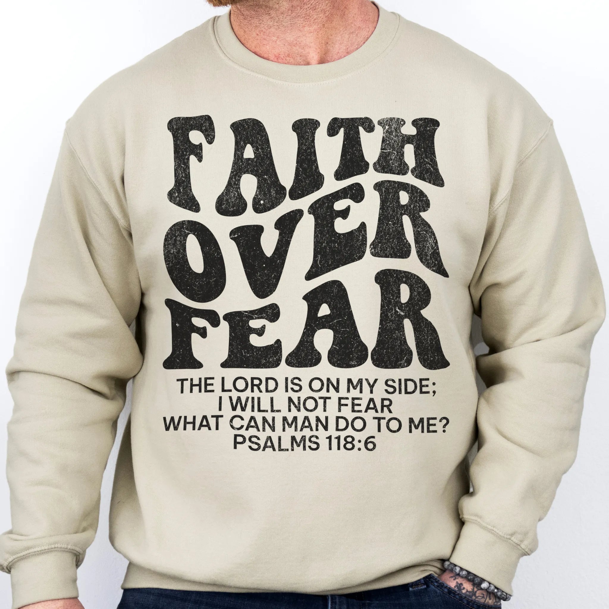 Sand Oakley June sweatshirt, mens fit, left chest badge reads Faith Over Fear with cross, studio front view