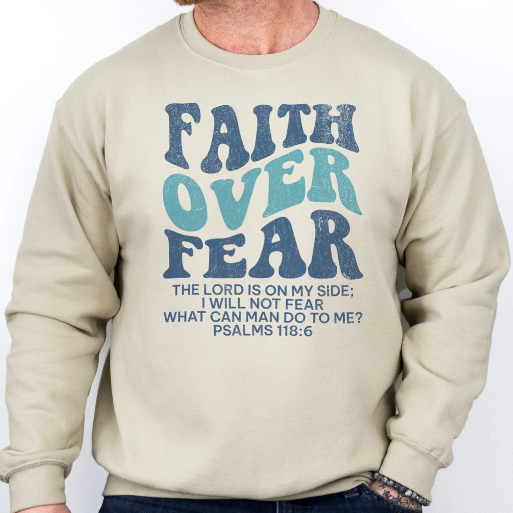 Sand Oakley June sweatshirt, mens fit, large front lettering reads Faith Over Fear with supporting lines The Lord Is On My Side I Will Not Fear What Can Man Do To Me, studio front view