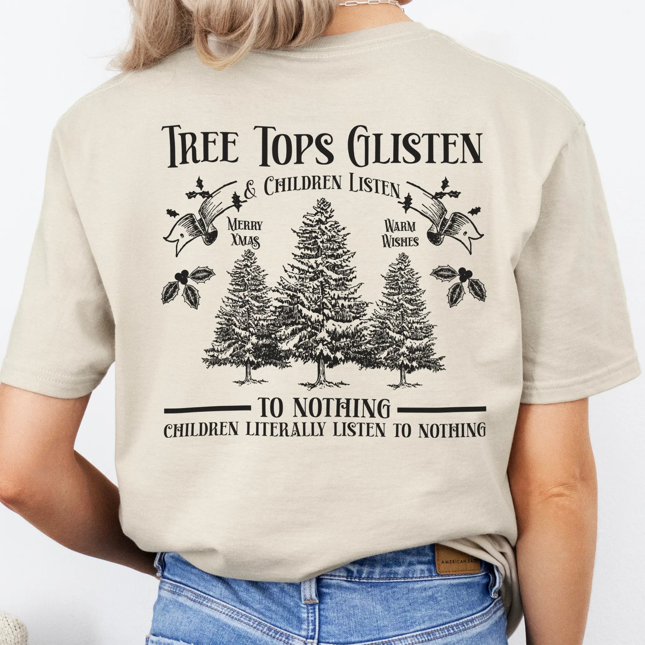 Sand Oakley June tee large back print Tree Tops Glisten and Children Listen to Nothing with three evergreen trees, doves, and holly
