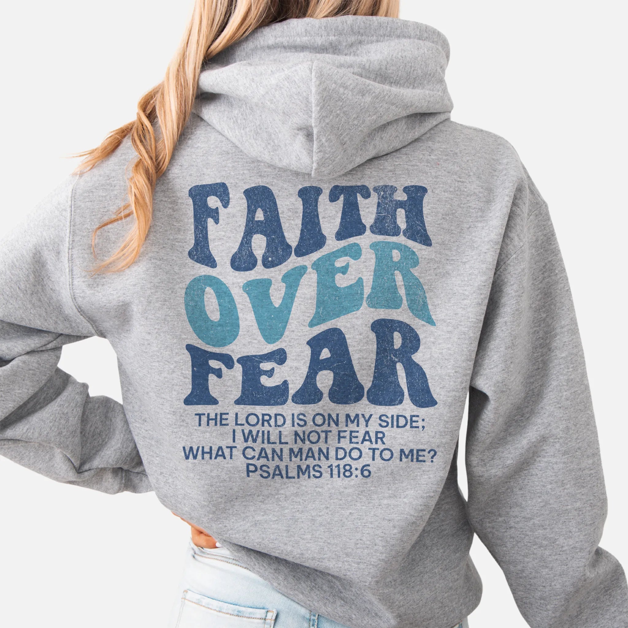 Sport Grey Oakley June hoodie, large back lettering reads Faith Over Fear with supporting scripture lines, hood up, studio back view