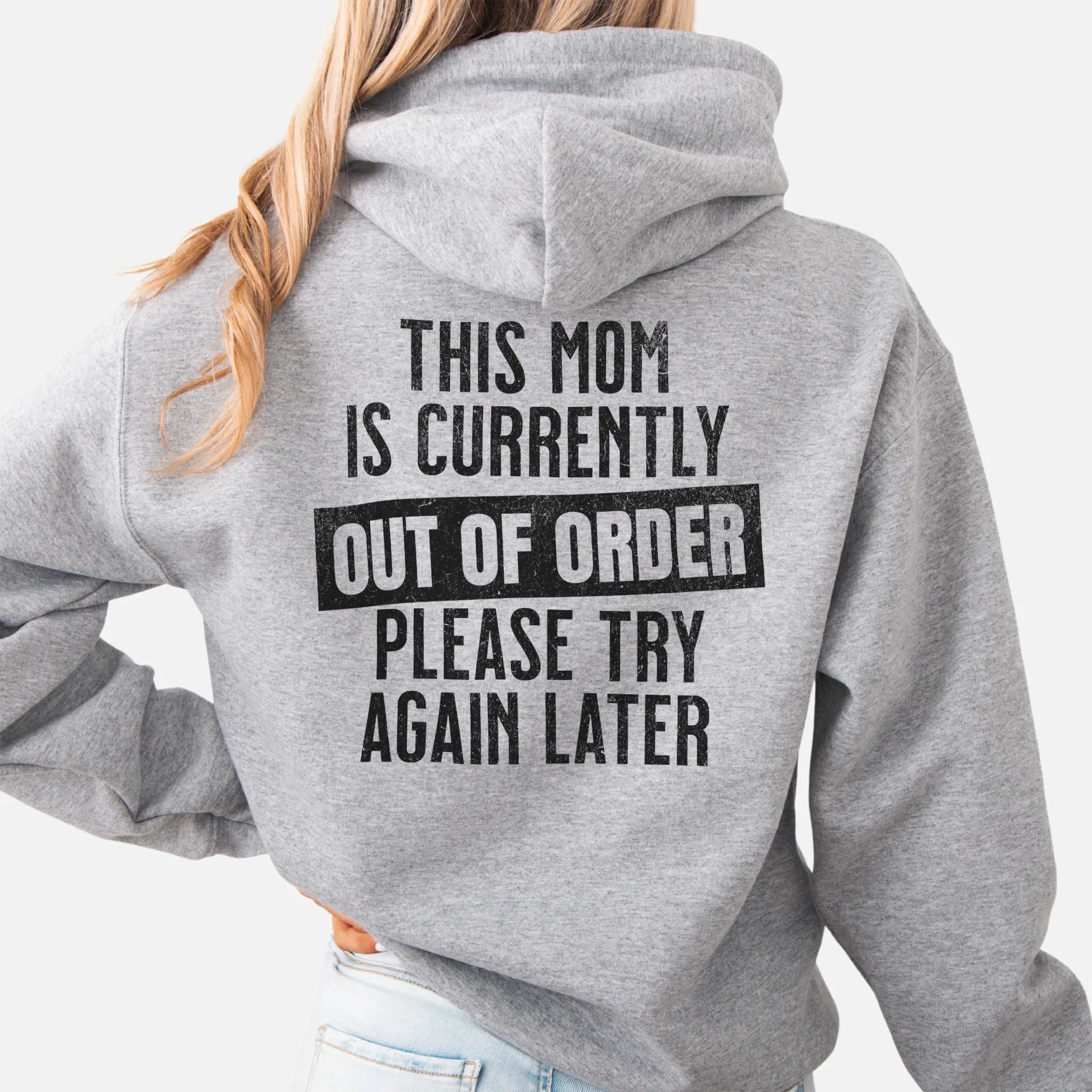 Sport Grey hoodie – large back text reads “This Mom Is Currently Out of Order, Please Try Again Later”, relaxed modern fit with hood up, studio back view