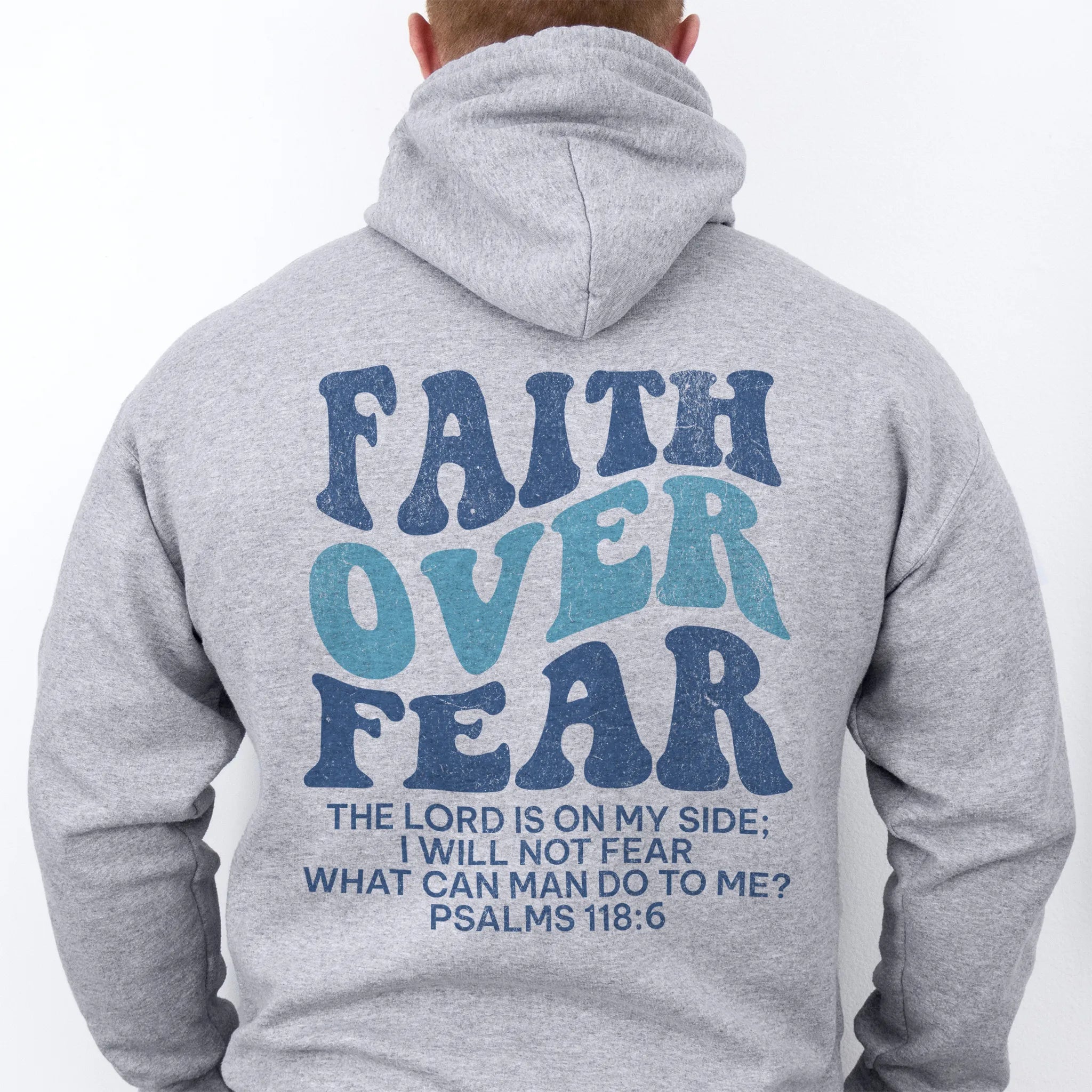 Sport Grey Oakley June hoodie, mens fit, large back lettering reads Faith Over Fear with supporting scripture lines, hood up, studio back view