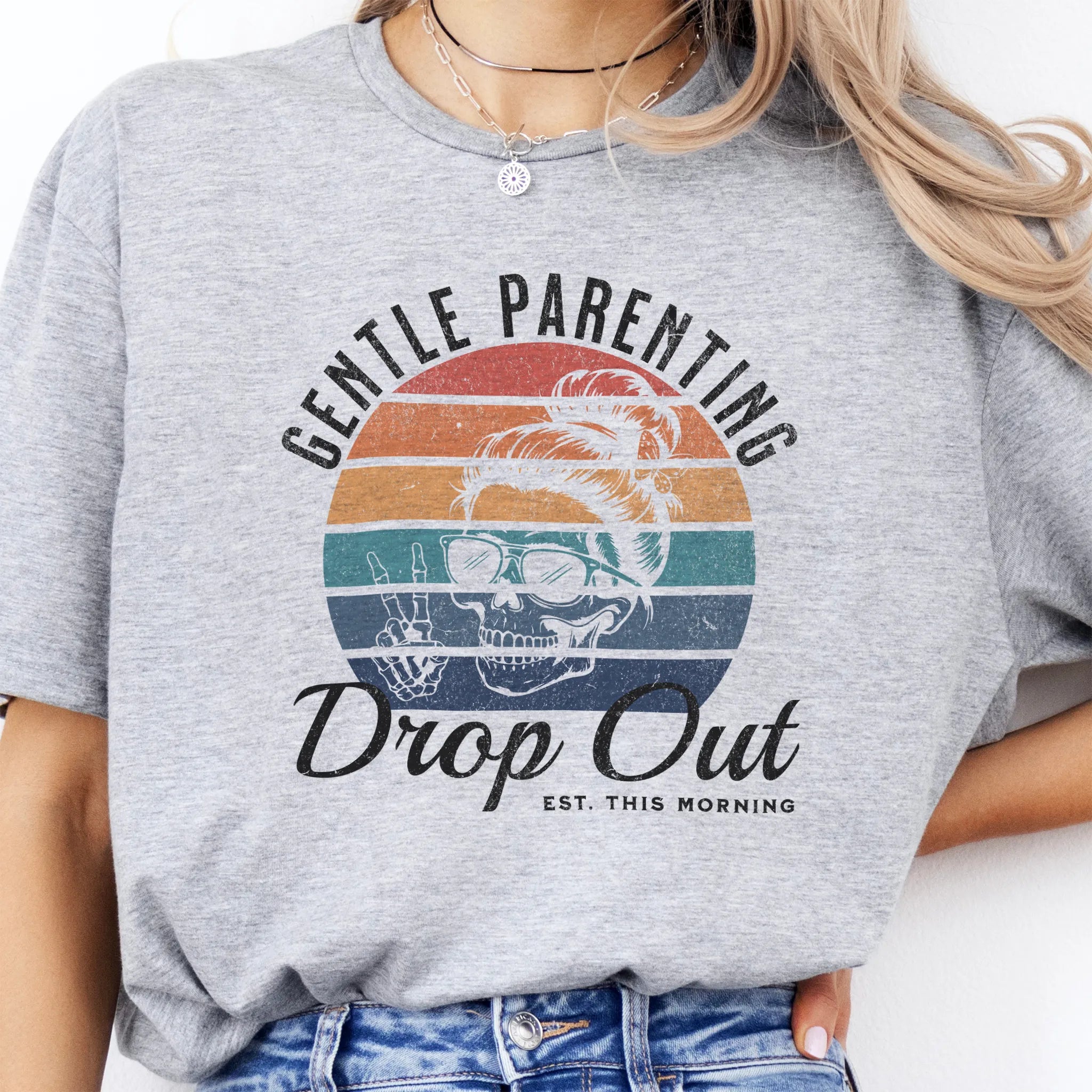 Sport Grey Oakley June T Shirt front view Gentle Parenting Drop Out large chest graphic skull with messy bun sunglasses peace sign round retro stripe badge text Est This Morning distressed print