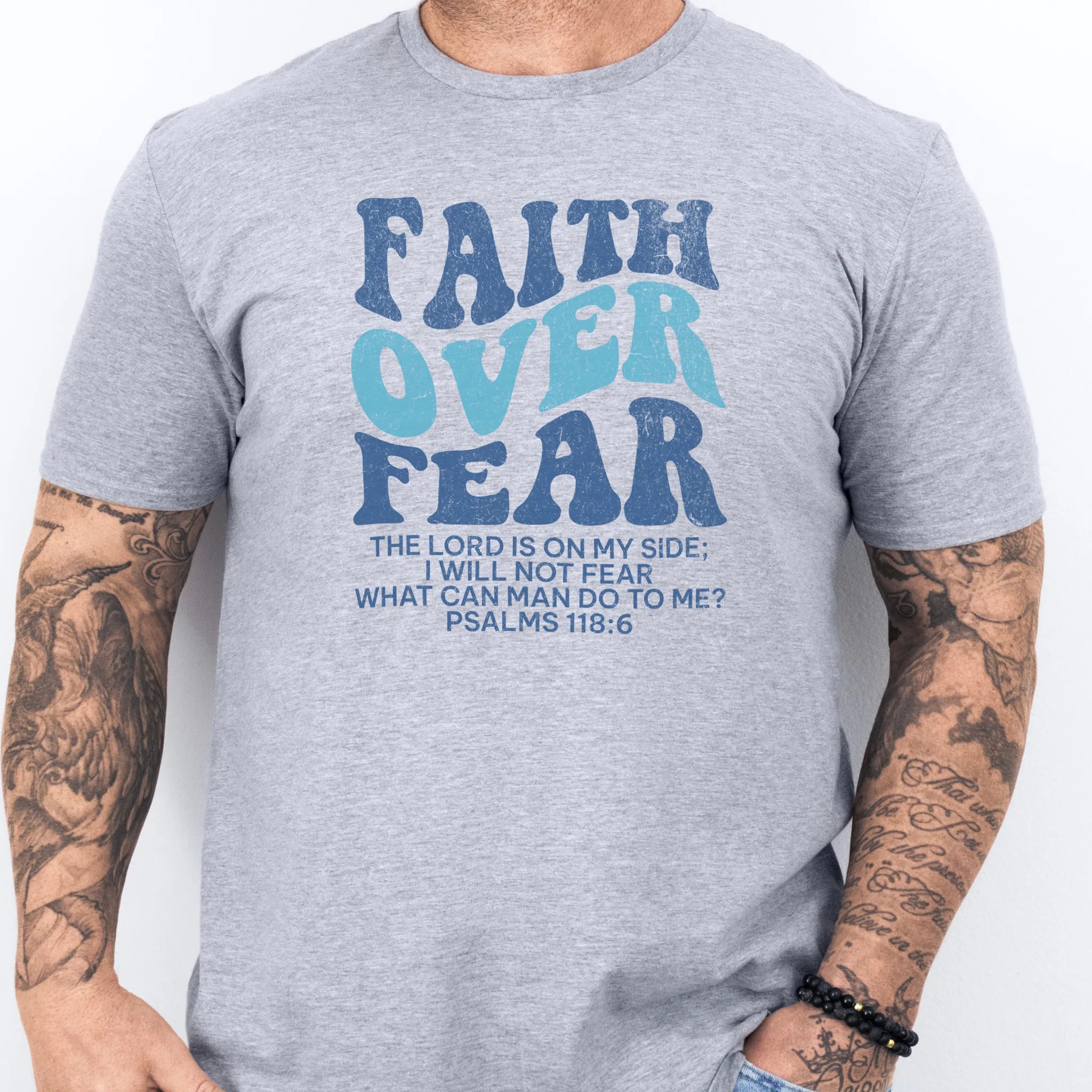 Sport Grey Oakley June t shirt, mens fit, large front lettering reads Faith Over Fear with supporting lines The Lord Is On My Side I Will Not Fear What Can Man Do To Me, studio front view