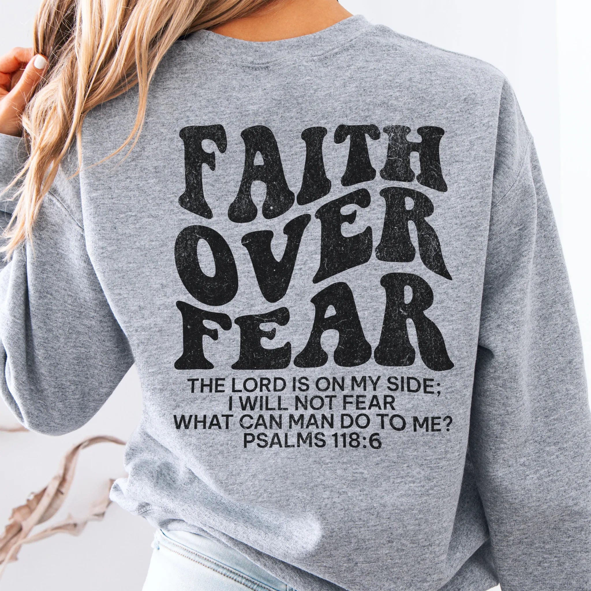 Sport Grey Oakley June sweatshirt, large back lettering reads Faith Over Fear with supporting scripture lines, studio back view