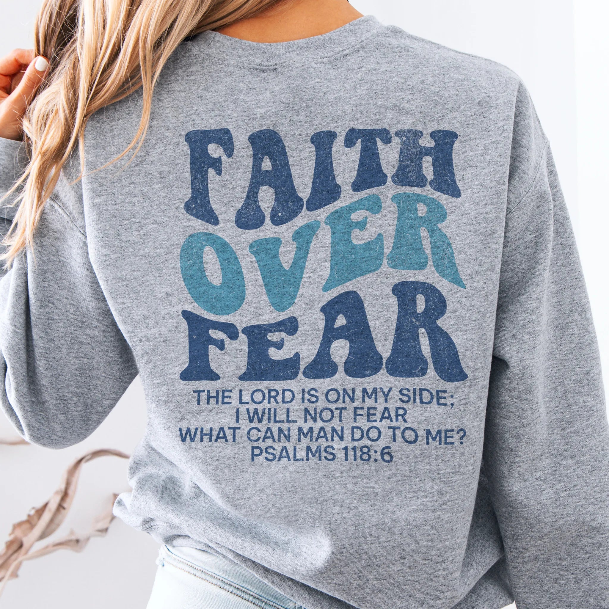 Sport Grey Oakley June sweatshirt, large back lettering reads Faith Over Fear with supporting scripture lines, studio back view