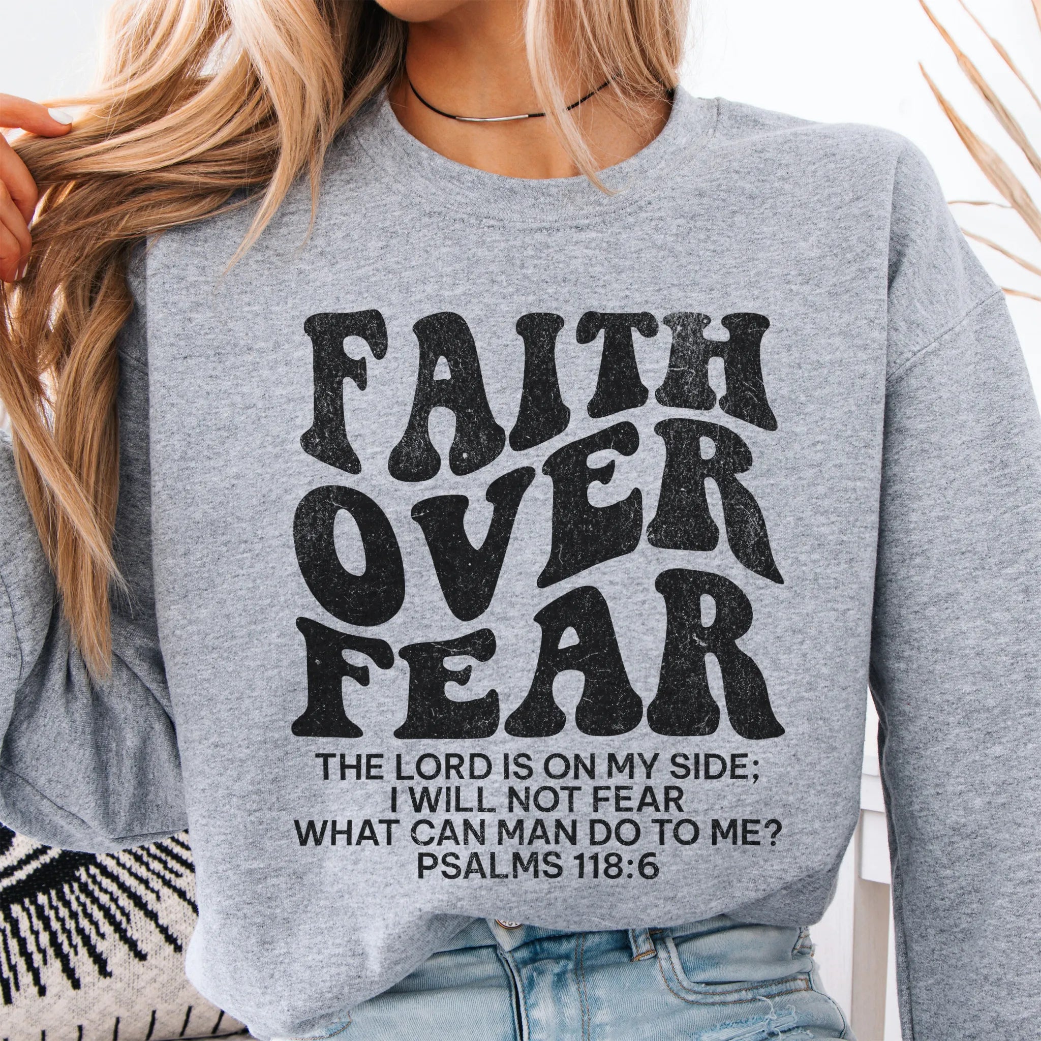Sport Grey Oakley June sweatshirt, large front lettering reads Faith Over Fear with supporting lines The Lord Is On My Side I Will Not Fear What Can Man Do To Me, studio front view
