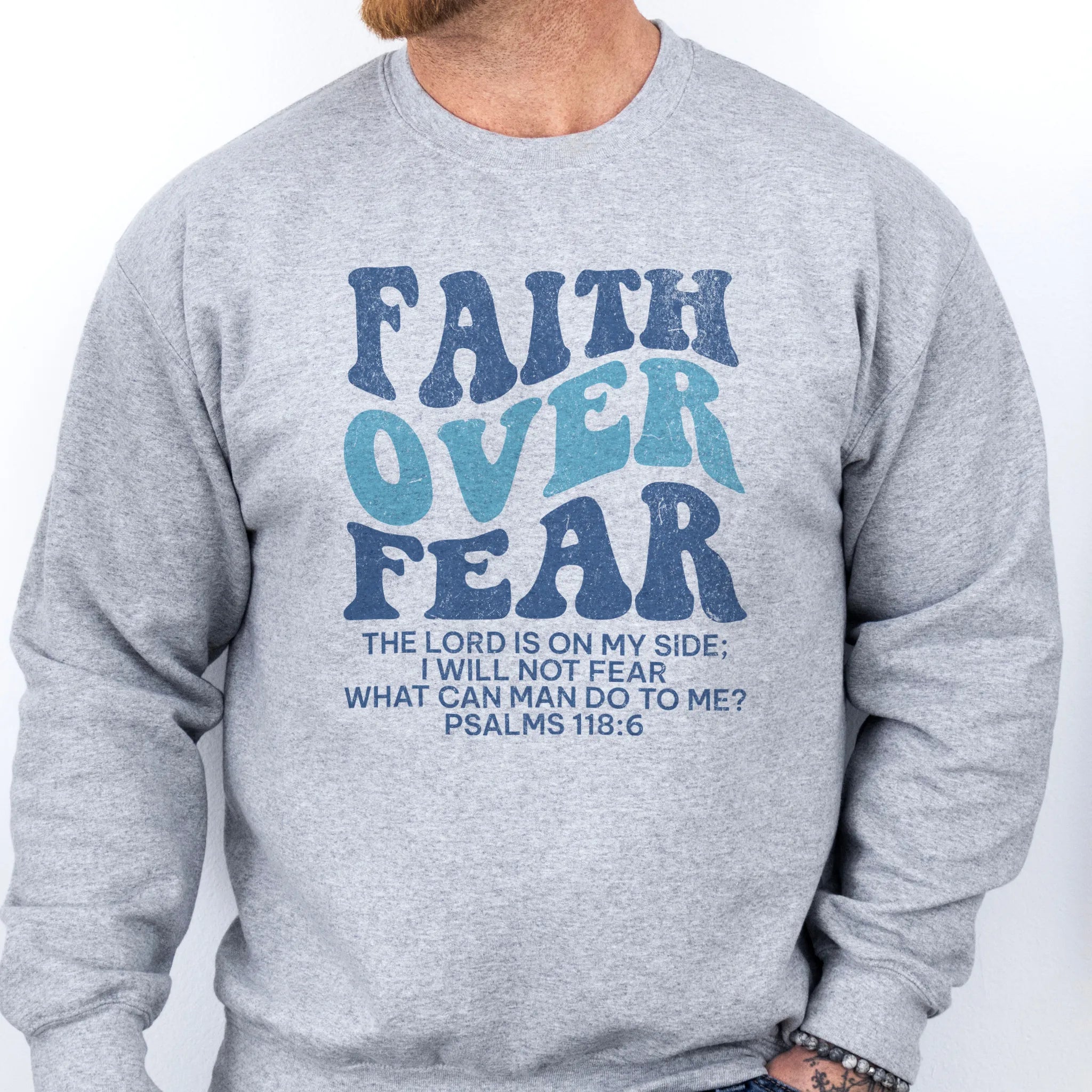 Sport Grey Oakley June sweatshirt, mens fit, large front lettering reads Faith Over Fear with supporting lines The Lord Is On My Side I Will Not Fear What Can Man Do To Me, studio front view
