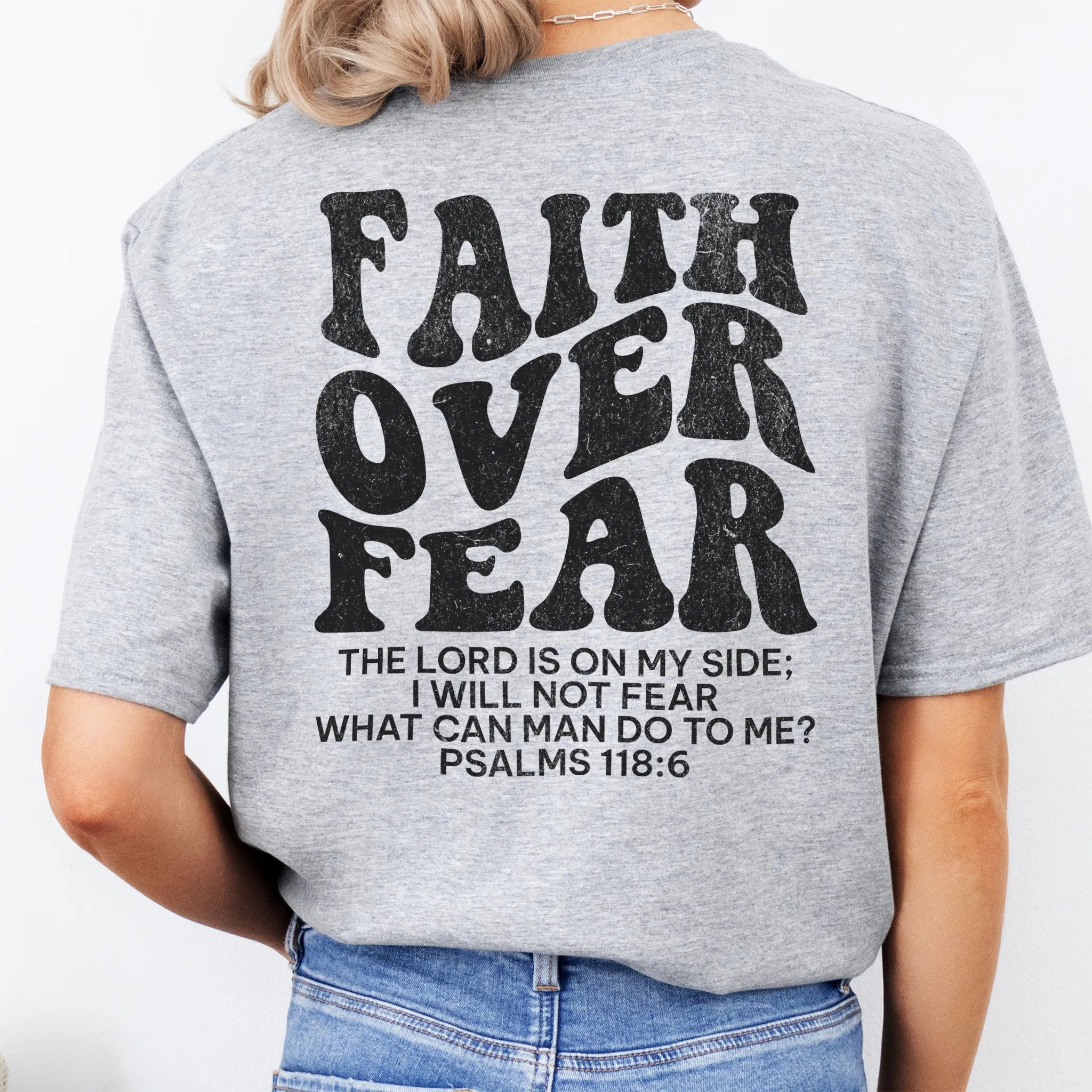 Sport Grey Oakley June t shirt, large back lettering reads Faith Over Fear with supporting scripture reference Psalms one eighteen six, studio back view