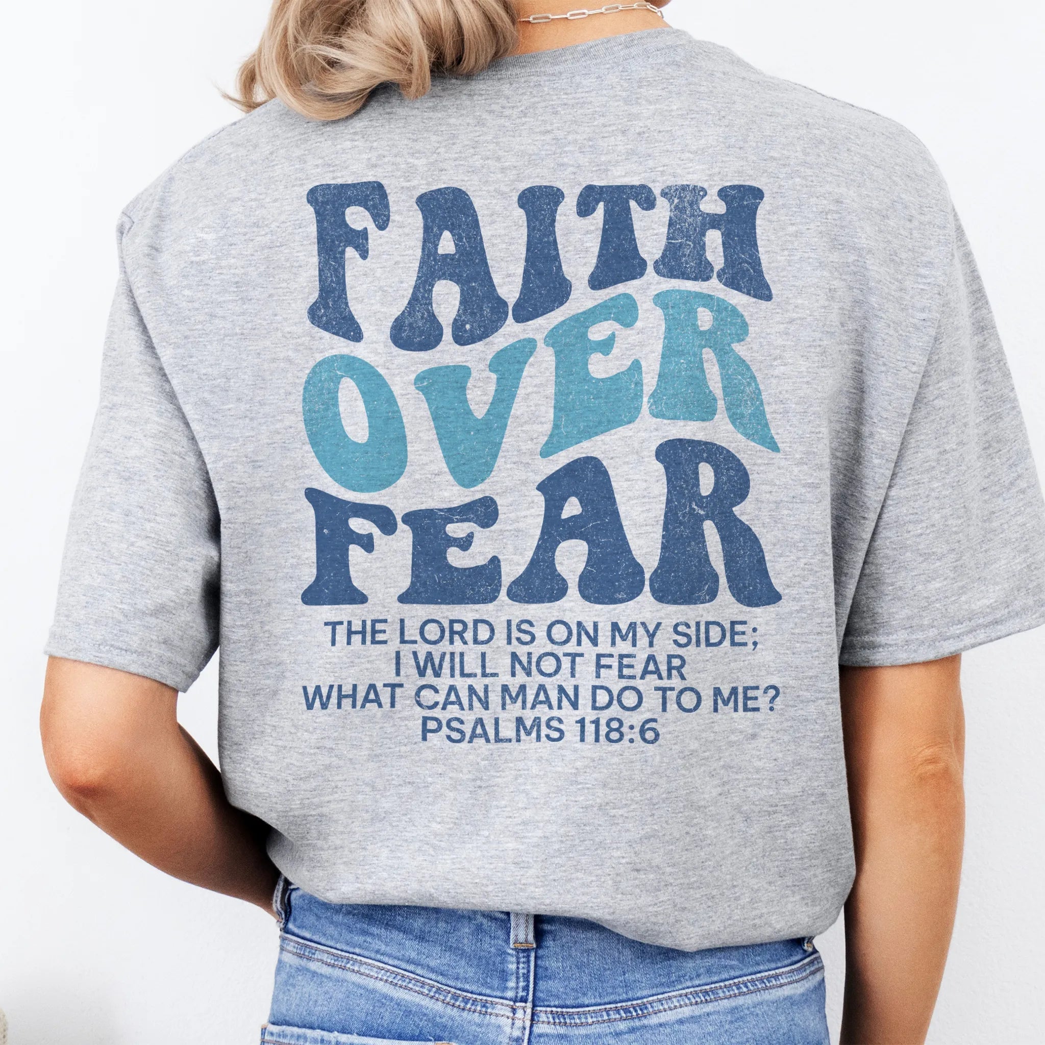Sport Grey Oakley June t shirt, large back lettering reads Faith Over Fear with supporting scripture lines, studio back view