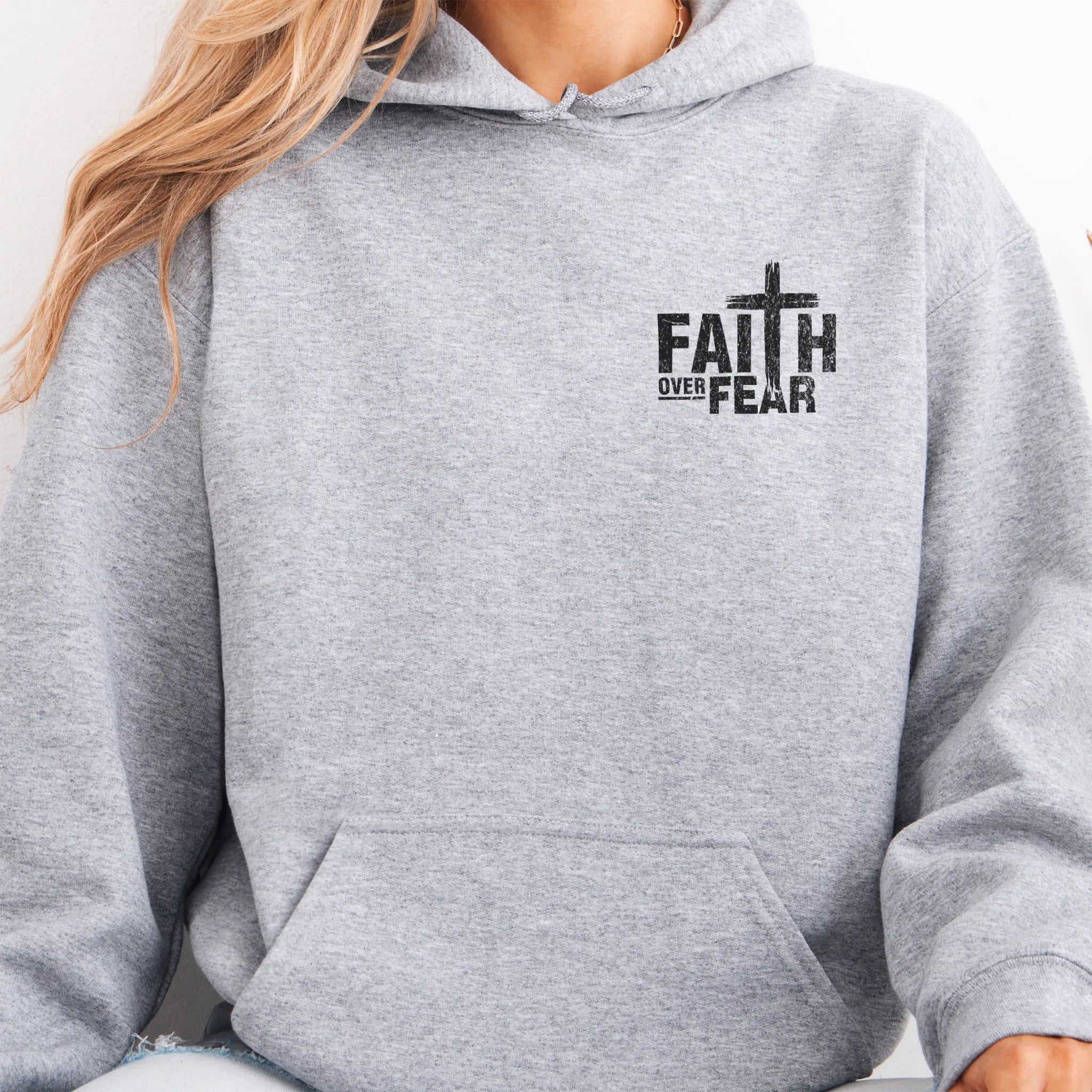 Sport Grey Oakley June hoodie, left chest badge reads Faith Over Fear with small cross, kangaroo pocket and relaxed modern fit, studio front view