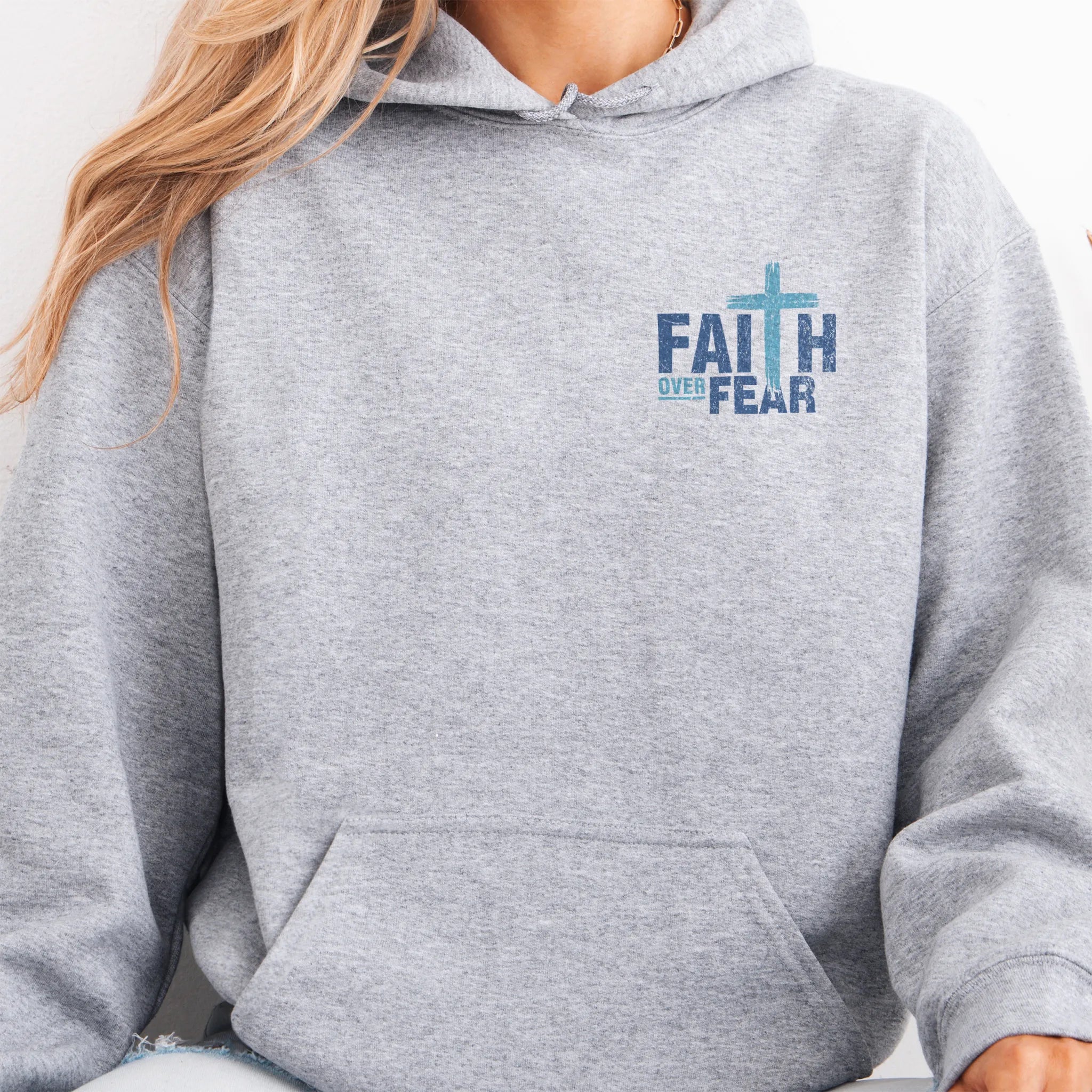 Sport Grey Oakley June hoodie, left chest badge reads Faith Over Fear with small cross, kangaroo pocket and relaxed modern fit, studio front view