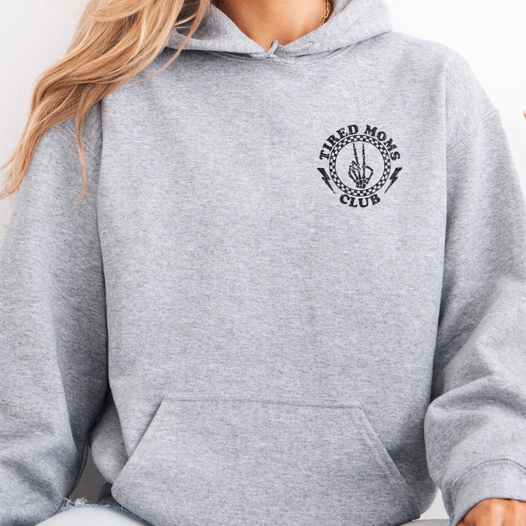 Sport Grey Oakley June Hoodie front view small left chest Tired Moms Club badge crest kangaroo pocket drawstrings visible distressed print